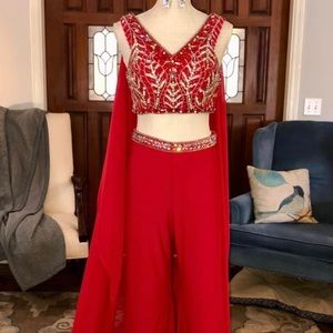 Red two piece fun fashion jumpsuit w/ custom cape. Beaded top and belt of pants